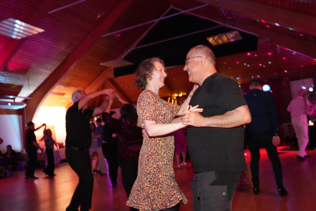 A couple laughing together while dancing at a Buckingham freestyle.